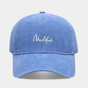 Gros plan de la broderie blanche New York sur la casquette en coton bleu délavé