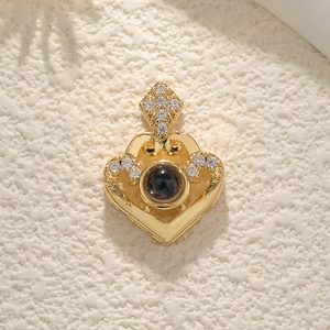 Golden heart projection necklace with crown detail and small diamonds on beige background