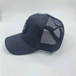 Navy blue trucker hat with mesh back and letter G shield logo in a side view