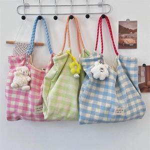 Three colorful checkered canvas tote bags in pink, green, and blue with rope handles