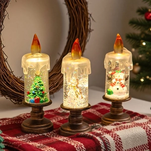 Trois bougies LED de Noël avec ange, bonhomme de neige et sapin sur nappe à carreaux