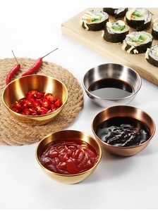 Top view of gold, silver, and rose gold stainless steel sauce bowls with condiments