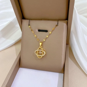 Detail of a sparkling four-leaf flower necklace with movable zircon in a jewelry box