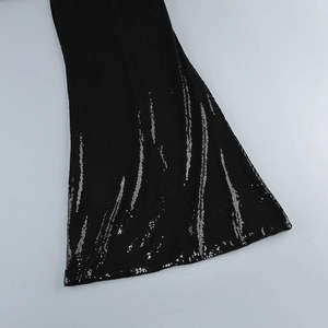 Detail of silver sequin vertical stripes on black fabric with flared sleeve craftsmanship