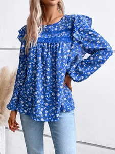 Detail view of floral blue shirt with lace patchwork and ruffled long sleeves