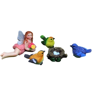 Miniature resin flower fairy and colorful birds garden figurine set on white background