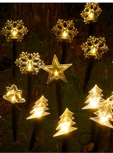 Outdoor Christmas solar garden lights with LED star, snowflake, and bell shapes on lawn