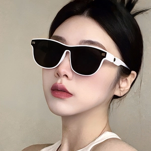 Fashionable white oval sunglasses with black lenses shown on a female model