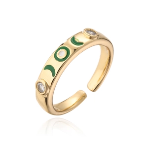 Detail of 18K gold ring featuring green enamel moon design and clear zircon stones