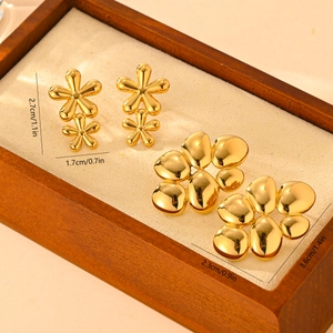 Detailed size view of 18k gold plated flower stud earrings on a wooden display