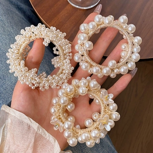 Elegant pearl hair ties and bracelets set with floral rhinestone details