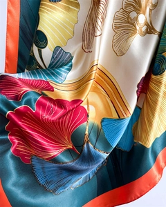 Close-up of silky ginkgo leaf print scarf with fine textures and smooth satin finish