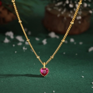 Detailed macro view of S925 silver necklace featuring a red heart-shaped gemstone pendant