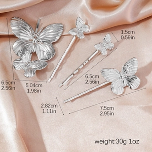 Elegant 4-piece silver metal butterfly hair clip set on luxurious pink silk background