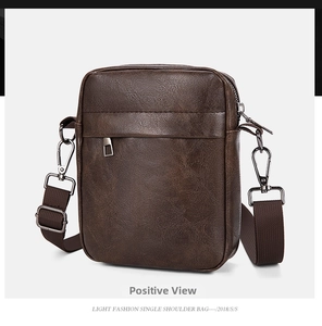 Detail of dark brown pebble faux leather crossbody bag with silver zipper and strap