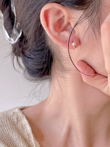 Detail of 925 silver gold pearl earrings and hoop set shown on a model for daily style