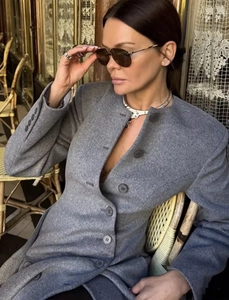 Detailed shot of grey wool coat with resin buttons and elegant round neck collar