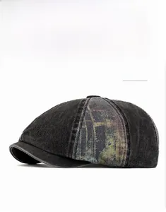 Detail of washed denim newsboy cap featuring retro artistic print and vintage texture
