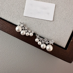 Elegant silver crawler earrings featuring white pearls and sparkling cubic zirconia stones