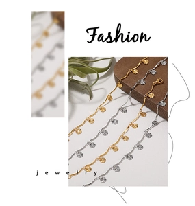 Detail of sunburst pendants on gold and silver titanium steel bracelets and anklets