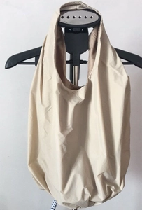 Detail view of the beige pleated canvas tote bag's soft texture and handle design