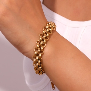 Detail showing the K18 engraved gold tag and triple-layer woven stainless steel chain