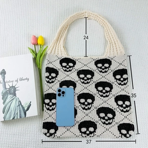 Flat lay of knit tote bag with skull pattern showing 37cm width and 35cm height dimensions