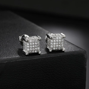 Macro shot of silver square stud earrings with micro-pave cubic zirconia in hip hop style