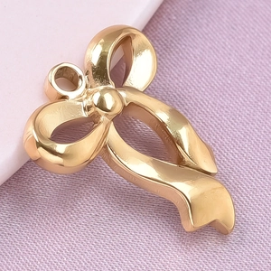 Macro view of gold stainless steel bow pendant with a smooth polished finish