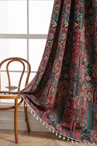 Detail of bohemian geometric jacquard curtain fabric with white cotton fringe tassels
