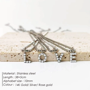 Close-up detail of stainless steel box chain with pearl-encrusted LOVE letter pendants.