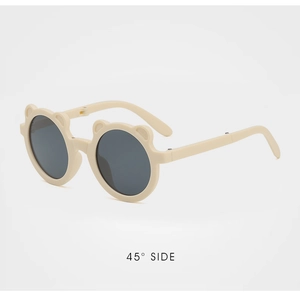 Detailed 45-degree side view of cream-colored kids' bear ear folding sunglasses
