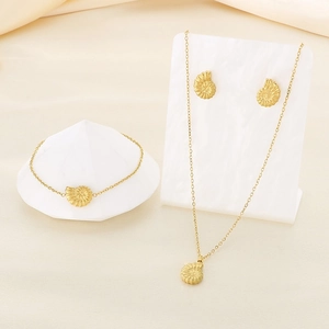 Detailed view of a gold-tone stainless steel seashell jewelry set including necklace and earrings
