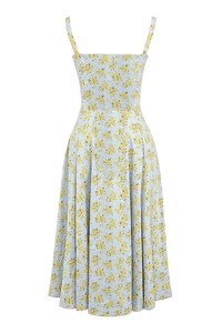Detail of light blue summer dress featuring vibrant yellow floral print and slit design