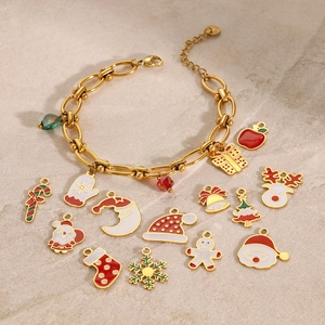 Flat lay of gold stainless steel bracelet with 14 colorful Christmas themed charms