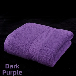 Detail of soft deep purple cotton bath towel with textured geometric woven border design