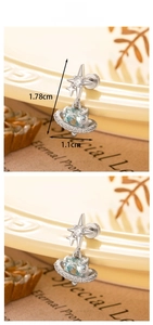 Detailed view of heart-shaped Saturn stud earring with light blue stone and crystal accents