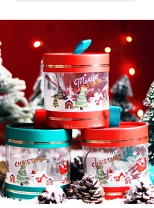 Close-up of Christmas round gift boxes in red and green with transparent PET windows