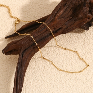 Detailed view of 18K gold plated stainless steel link chain with lobster clasp and extender
