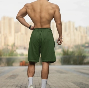 Detailed back view of dark green men's athletic shorts with elastic drawstring waist