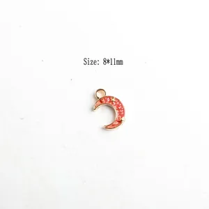 Detailed view of pink enamel crescent moon pendant with gold star relief and size mark