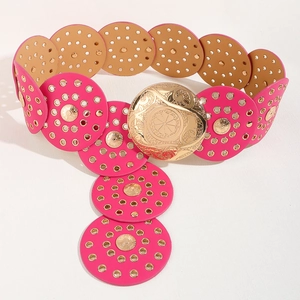 Detail of pink and tan leather disc belt with gold eyelets and ornate metal buckle
