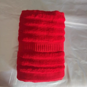 Red wave texture bamboo fiber wedding towel folded on a clean white surface