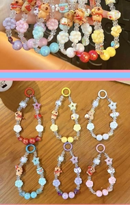 Detailed close-up showing colorful Capybara beaded phone charms with stars and flowers
