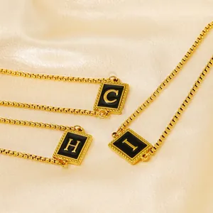 18K gold plated stainless steel initial necklace set with black enamel letter pendants