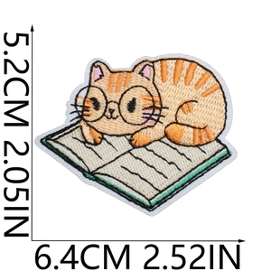 Cute ginger cat reading book embroidery patch with dimensions 6.4x5.2CM for clothing decor