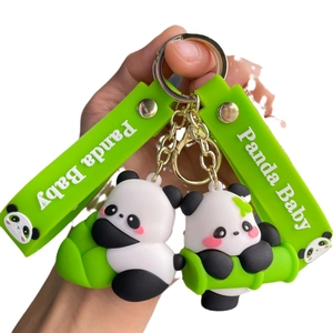 Cute cartoon panda holding bamboo keychain with green silicone strap and gold metal ring