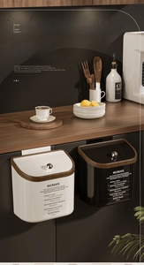 Detail of hanging kitchen bins with wood grain lid and crystal knob for modern waste management