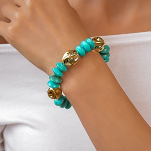 Detailed close-up of handmade acrylic beaded bracelet with turquoise and gold irregular beads
