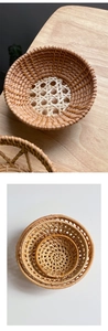 Nesting set of three round handmade rattan storage baskets with dual-tone woven texture